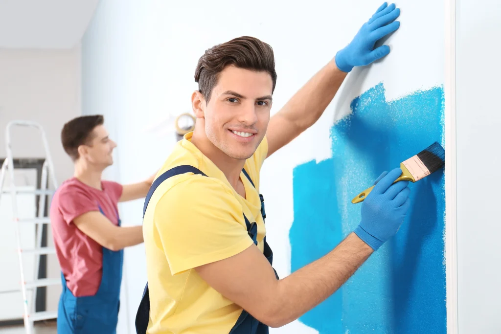 men painting a wall bright blue indoors 2026 09 22 11 50 28 utc