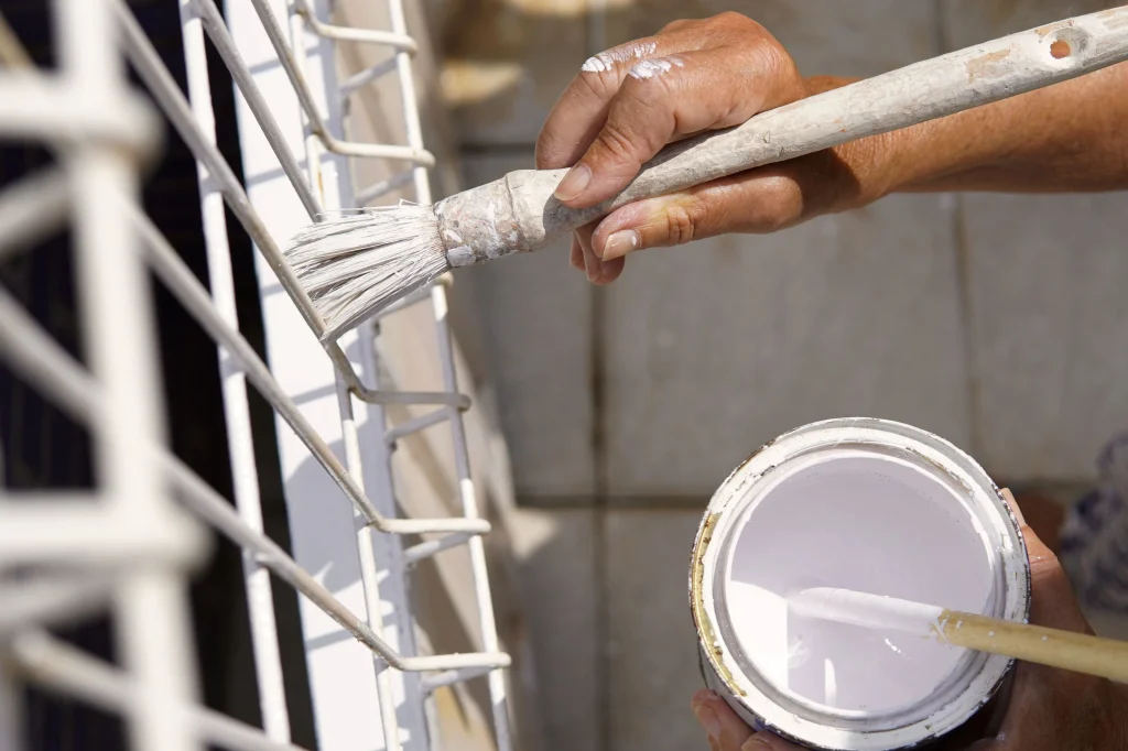 applying white paint on metal with brush 2026 09 23 11 16 29 utc