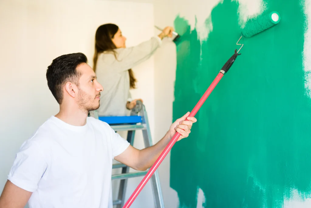 couple painting interior walls together in home 2026 09 22 03 18 33 utc