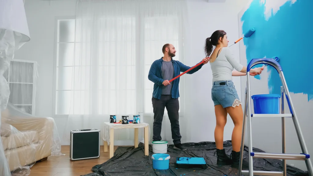 couple painting wall together in home interior 2026 09 21 19 13 40 utc