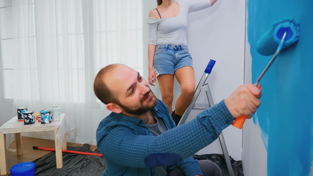 couple painting wall together in their home 2026 09 21 18 31 07 utc