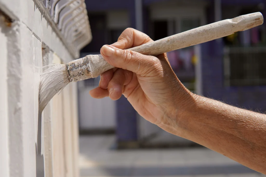 hand painting white trim outdoors in daylight 2026 09 23 11 13 14 utc