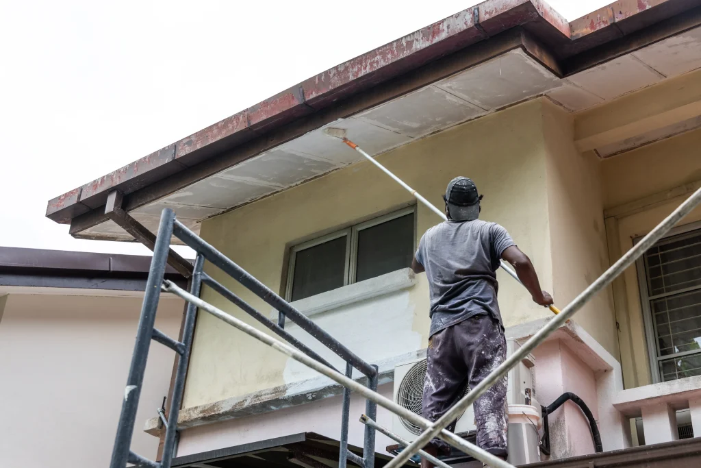 man painting house exterior while standing on scaf 2026 09 23 21 13 23 utc