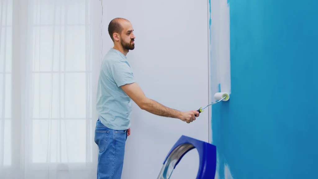 man painting wall with roller in bright room 2026 09 21 18 29 48 utc