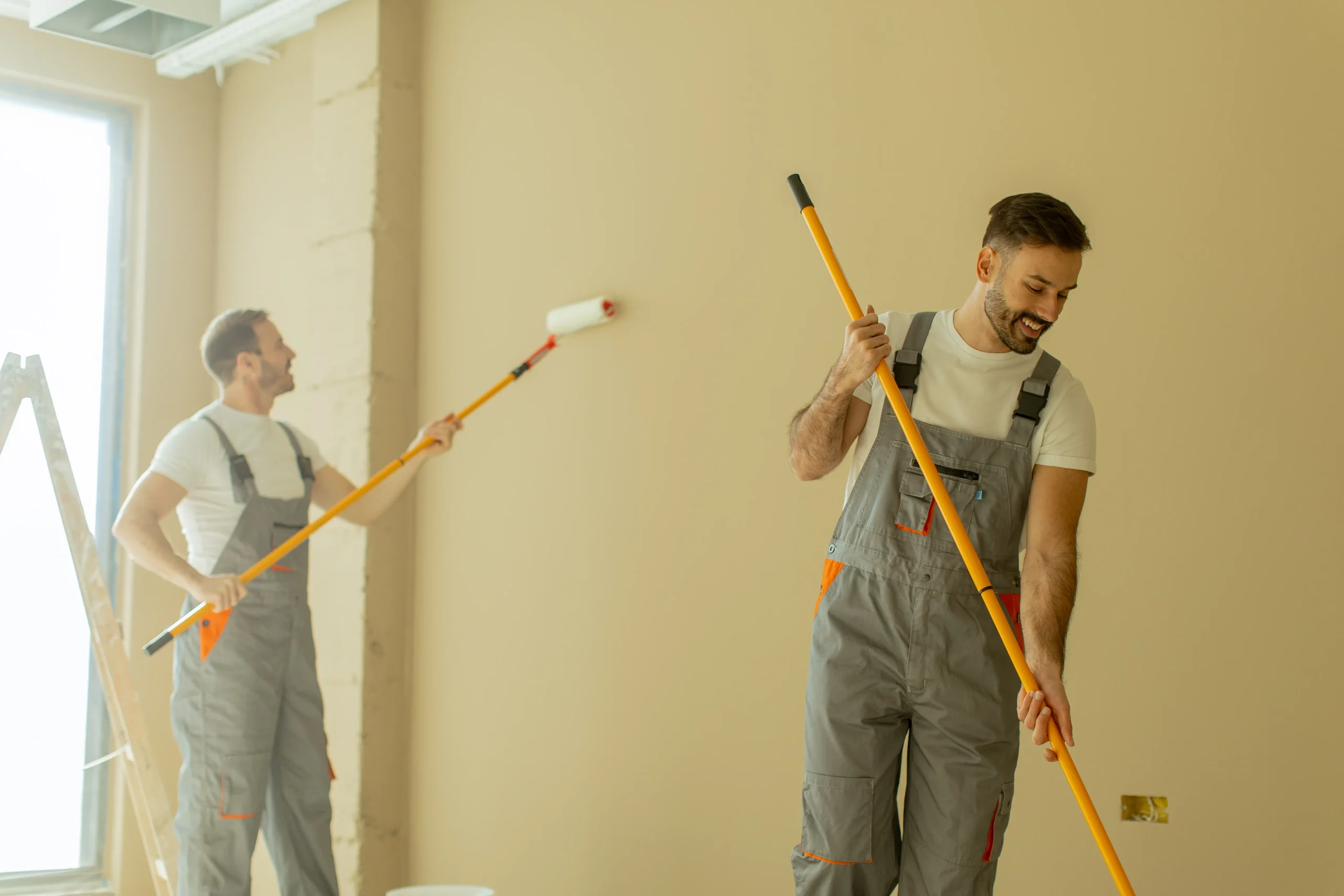 men painting interior wall with roller 2026 09 25 01 48 48 utc
