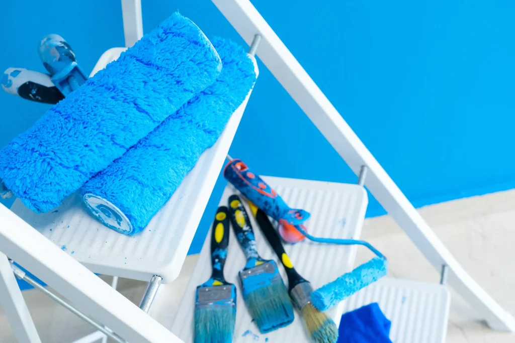 paint supplies on a ladder with bright blue paint 2026 09 21 02 09 27 utc
