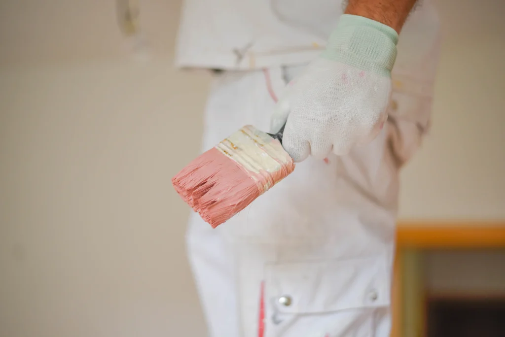 painter with brush ready to begin painting room 2026 09 21 16 17 52 utc