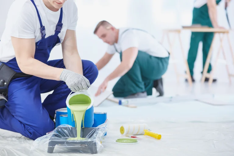 painters pouring green paint at indoor constructio 2026 09 21 02 08 26 utc