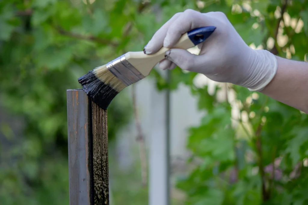 painting a metal post with black paint outdoors 2026 09 24 06 52 29 utc