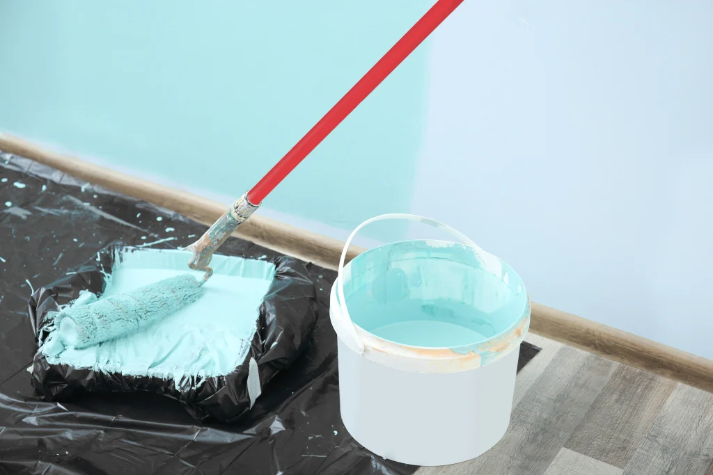 painting wall interior with paint roller and bucke 2026 09 25 01 23 05 utc