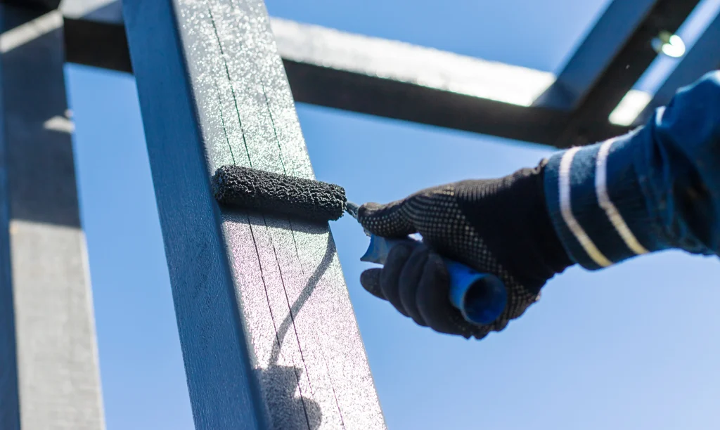 worker applying paint to metal construction frame 2026 09 24 15 07 19 utc